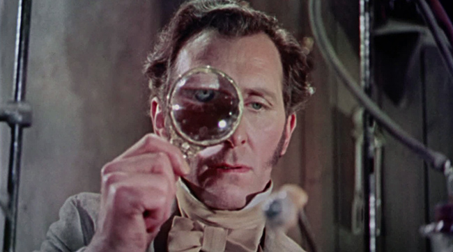 Peter Cushing as Victor Frankenstein gets a good look at some creature parts in Hammer's THE CURSE OF FRANKENSTEIN (1957)