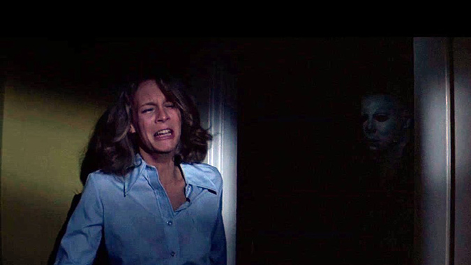 Laurie (Jamie Lee Curtis) fails to escape The Shape in John Carpenter's independent horror classic HALLOWEEN (1978).