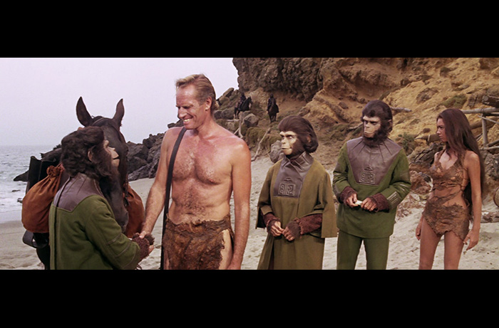 In a finale scene from PLANET OF THE APES: (L to R) Lou Wagner as Lucius, Charlton Heston, Kim Novak as Zira, Roddy McDowall as Cornelius, and Linda Harrison as Nova.