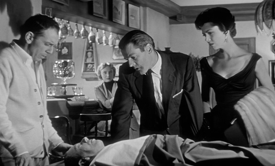 A lifeless copy of Jack is discovered in INVASION OF THE BODY SNATCHERS. (L to R): King Donovan, Carolyn Jones, Kevin McCarthy, Dana Wynters.