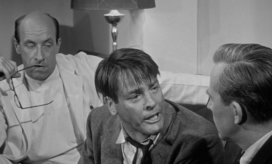 Miles (Kevin McCarthy) is desperate for Dr. Bassett (Richard Deacon) and Dr. Hill (Whit Bissell) to believe that an alien conspiracy is threatening humanity, in INVASION OF THE BODY SNATCHERS.